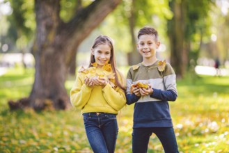 Friendship between siblings. Siblings together outside with bright coloured background. Kids autumn