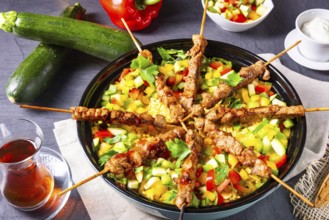 Lamb kebabs with curry rice and various vegetables