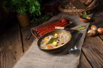 Rustic sauerkraut soup with bacon and sausage