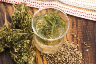 Cannabis herbal tea on wooden background