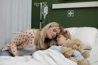 A loving mother gently comforts her sick child, who is lying in a hospital bed, creating a truly