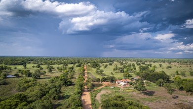 Aerial view of Transpantaneira dirt road with dramatic sky and rain crossing the typical landscape