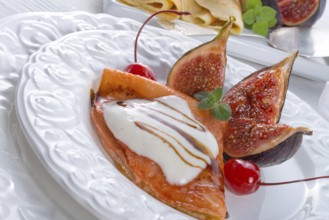 Flambiertes pfannkuchen mit feigen und kirschen