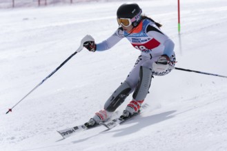 Mount skier Naumova Alexandra Murmansk Region skiing down mount slope. International Ski Federation