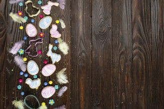 Sugar sprinkles, candies, feathers, cookie cutters, Easter frosted cookies in shape of egg chicken