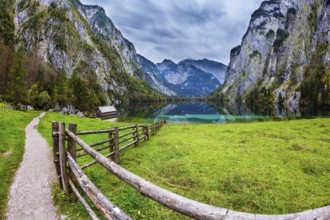 The concept of active tourism and ecotourism. Bavarian Alps. Magic blue lake Obersee and fenced