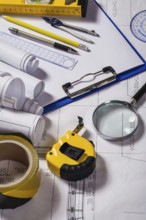 Wiew on a typical engineer workplace with blueprint and measuring tools vertical
