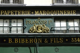 Shop front with golden letters on a green background. Landscape format. Front of a shop with golden
