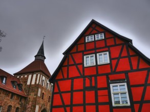 Half-timbered house and gothic church with tower in red and black, stralsund, mecklenburg, germany