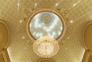 A picture of a chandelier in the ceiling of Qasr Al Watan