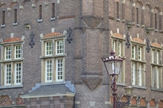 Detail of a historic brick house with windows and lantern, Amsterdam, Netherlands