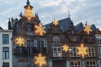 Old buildings at dusk with decorative snowflake lights, nijmegen, the netherlands