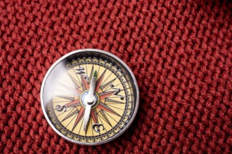 Compass tool on red texture fabric