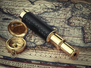 Traveling theme: vintage telescope and compass at antique (17 century) map