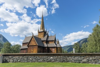 Lom stave church (Lom stavkyrkje) with graveyard foreground, Lom, Norway, Europe