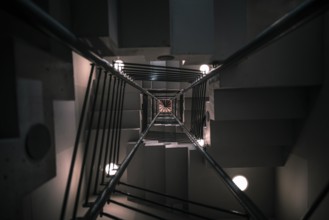 Abstract architectural image with a modern staircase on many levels, viewed from down to up, with