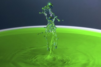 A powerful splash of green liquid with eye-catching water sculptures, water droplets, collision,