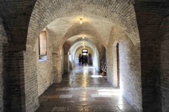 Basilica Santa Maria degli Angeli, Assisi, Umbria, Italy, A long vaulted corridor with brick walls
