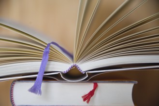 Fabric ribbon as bookmark - open book with bookmark ribbon, close-up