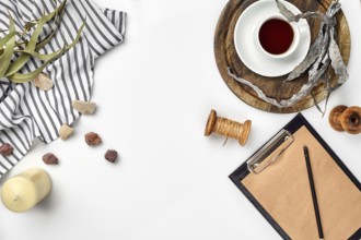 Opened diary with pen on the table near hot cup of black tea. Top view, flat lay. Copy space. Still