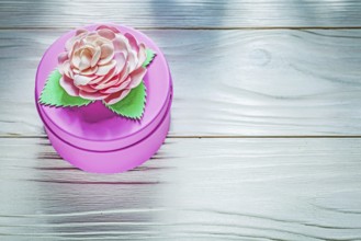 Round pink present box on wooden board celebrations concept