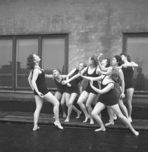 Gymnasts in the 1940s. A group of women gymnasts are training together on a top of a building.
