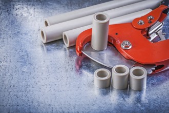 Set of pipe coupling tools on metallic background construction concept