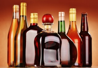 Bottles of assorted alcoholic beverages including beer and wine