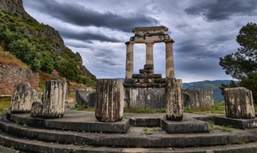 Ruins of Tholos of ancient Greek goddess Athena Pronaia in Delphi, Greece. Three Doric columns with