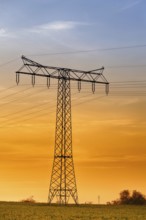 High-voltage power line High-voltage pylon in the sunset