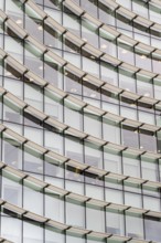 Abstract mosaic of geometric shapes adorns the modern building's facade, doubling as a captivating