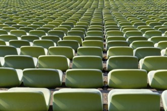 Many endless rows of enpty chairs in a stadium