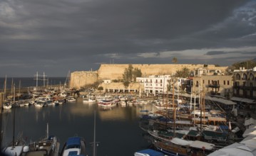 Harbour with luxury travel yachts and boats at sunset at Kerynia city harbor in Cyprus