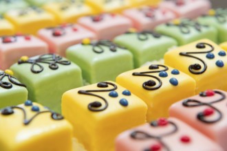 Many colorful petit fours with marzipan and chocolate