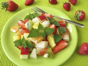 Fruit plate decorated with honeydew melon and sage