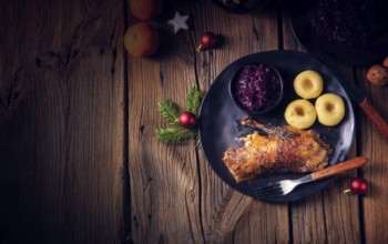 Roast goose with baked apples, red cabbage and dumplings