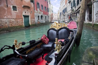 Gondola in Venice channel at the pier
