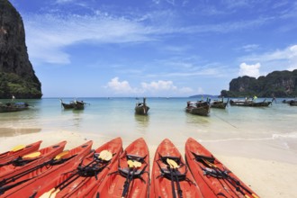 Red modern boats- canoes and boats classic Longtail awaiting tourists. Thailand, the southern