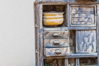 Gongju, South Korea, August 5, 2019: Closeup of miniature piece of kitchen furniture against white