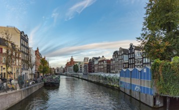 A picture of the Singel Canal and the Bloemenmarkt (flower market) of Amsterdam, at sunset
