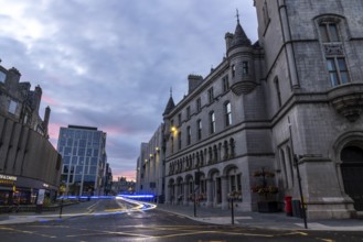 Emergency vehicle with flashing lights leaves traces of light, evening mood, Broadstreet with Town