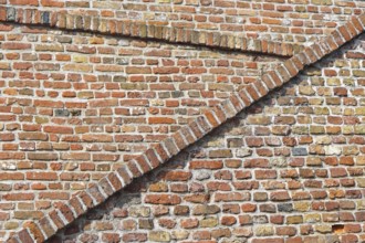 Old red brickwork walls with diagonal lines