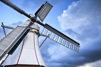 White Dutch windmill over blue sky via wide angle, Holland
