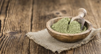 Stevia leaf powder (detailed close-up shot) on rustic wooden background