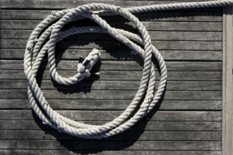 Nautical marine round thread over dried gray teak wood background