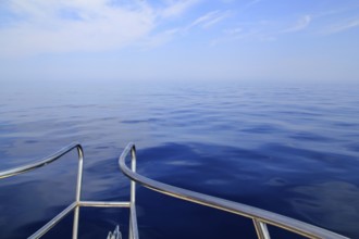 Boat sailing blue calm ocean sea bow railing in Mediterranean
