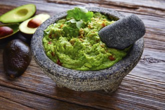 Avocado Guacamole on molcajete real Mexican traditional procedure