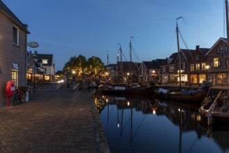 Evening mood, blue hour, old harbour at the Eemmeer, historic centre of Spakenburg,