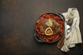Traditional Italian dish Ossobuco all Milanese made with cut veal shank meat with vegetable tomato