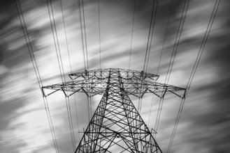 Details of a metallic structure of a high voltage electricity tower holding transmission wires to